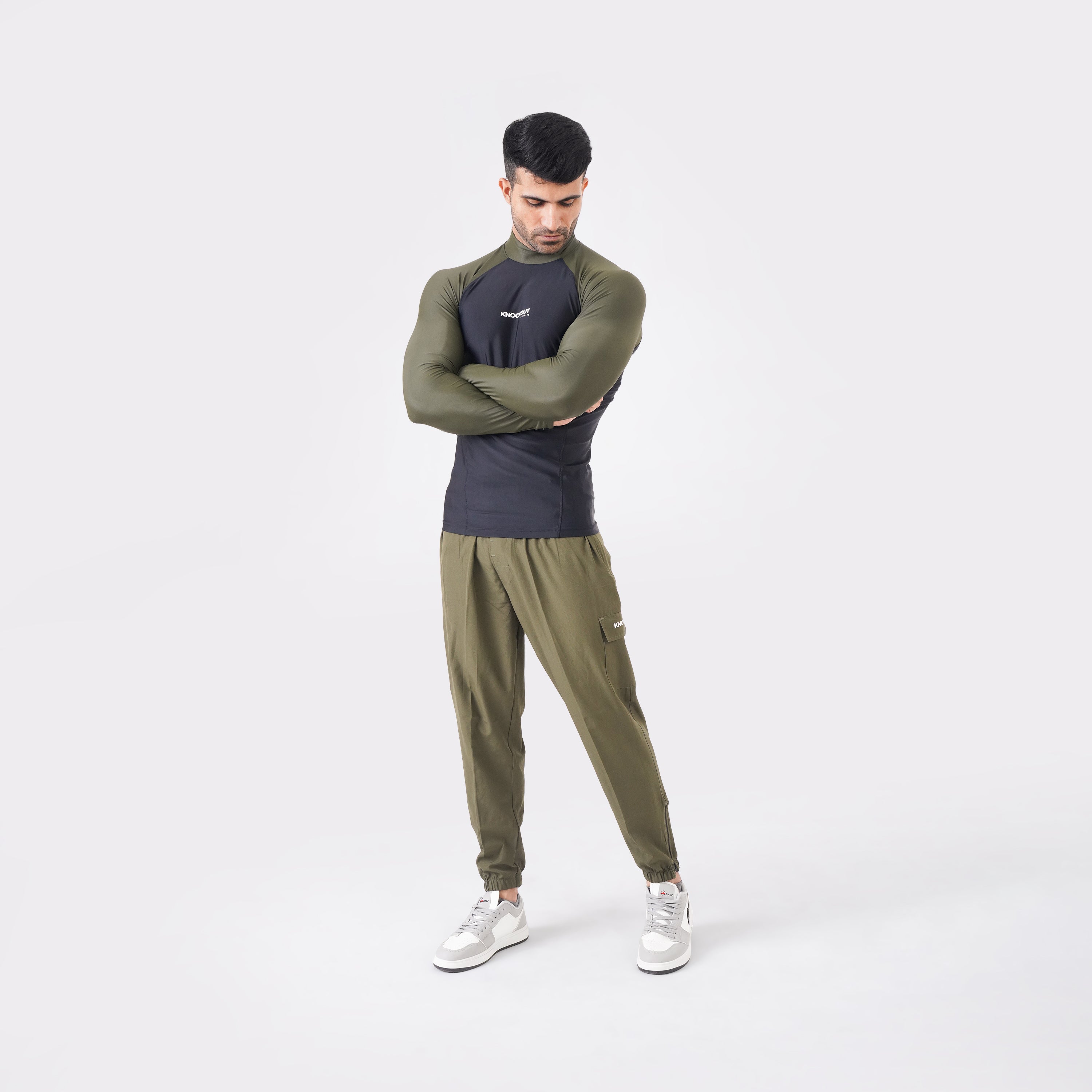 Black and Green high-neck long sleeve compression shirt for workouts.