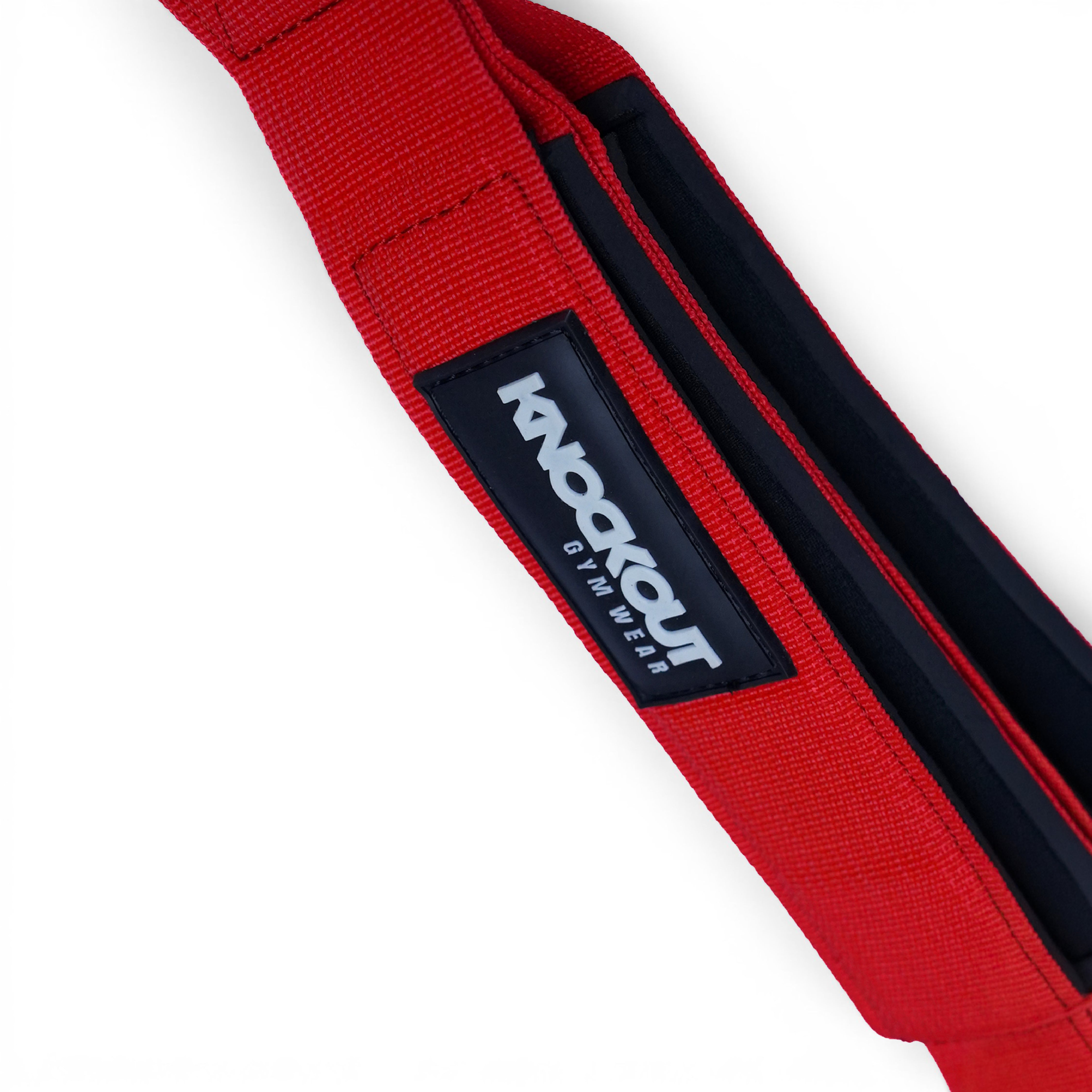 Close-up of a red webbed strap with a black label reading 'Knockout Gym Wear' on a white background.