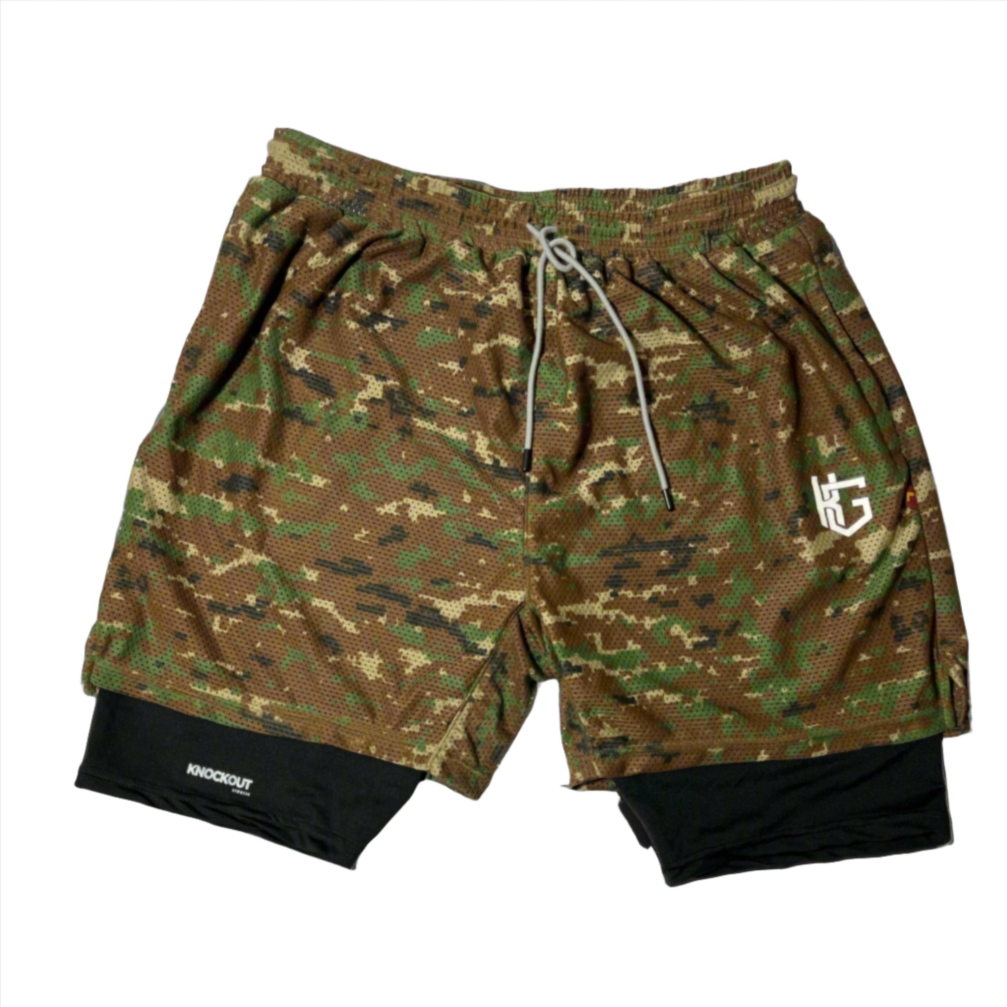 Elevate your workouts with Knockout Double Layer Camo Shorts – durable, moisture-wicking, and stylish with woodland camo and navy blue mesh layers.